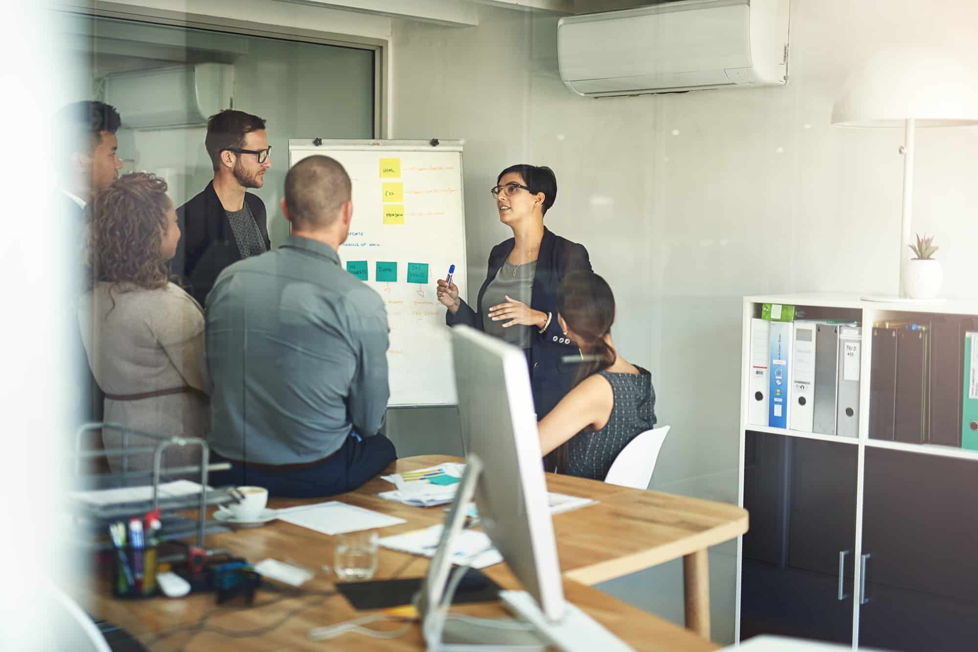 Streamlining her teams workflow. Shot of a presentation in progress in a modern office.